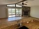 Living room with open floor plan, vaulted ceiling, stone fireplace, and access to outdoor living at 5956 Seaside Dr, New Port Richey, FL 34652