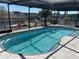 Screened-in pool with waterfront views and tropical landscaping, a great feature for relaxing and entertaining at 5956 Seaside Dr, New Port Richey, FL 34652