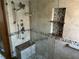Luxurious shower featuring a rain showerhead, multiple body sprays, a built-in bench, and pebble accents at 5956 Seaside Dr, New Port Richey, FL 34652