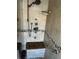 Luxurious shower featuring a rain showerhead, multiple body sprays, a built-in bench, and pebble accents at 5956 Seaside Dr, New Port Richey, FL 34652