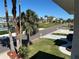 Charming street view showcasing lush lawns, palm trees, and inviting homes under a bright blue sky at 5956 Seaside Dr, New Port Richey, FL 34652