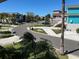 Scenic street view with well-maintained lawns, mature trees, and colorful homes under a clear blue sky at 5956 Seaside Dr, New Port Richey, FL 34652