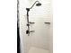 Modern shower featuring white subway tile, sleek black fixtures, and floating shelves at 6244 Warren Ave, New Port Richey, FL 34653
