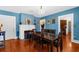 Dining room with fireplace, wood table, chandelier, and hardwood floors at 6244 Warren Ave, New Port Richey, FL 34653