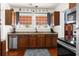 Kitchen with stainless steel appliances, wood cabinets, and a large window overlooking the backyard at 6244 Warren Ave, New Port Richey, FL 34653