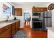 Bright kitchen featuring stainless steel appliances, wooden cabinets, and view to dining area at 6244 Warren Ave, New Port Richey, FL 34653
