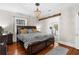 Bedroom featuring a dark wood bed frame, chandelier, hardwood floors, and a comfortable setting at 6244 Warren Ave, New Port Richey, FL 34653