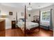 Main bedroom featuring hardwood floors, large bed, a chandelier, and an antique dresser at 6244 Warren Ave, New Port Richey, FL 34653