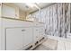 Bathroom features a single sink vanity with storage and shower/tub with curtain at 6652 Brambleleaf Dr, Spring Hill, FL 34606