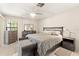 Comfortable bedroom featuring a ceiling fan and matching dressers with a padded bench at 6652 Brambleleaf Dr, Spring Hill, FL 34606