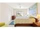 Serene bedroom with a large window, ceiling fan, and a spacious closet for storage at 6652 Brambleleaf Dr, Spring Hill, FL 34606
