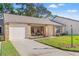 Inviting home exterior with a one-car garage, covered entry, and a well-kept lawn at 6652 Brambleleaf Dr, Spring Hill, FL 34606