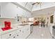 Kitchen with white cabinets and countertops, stainless steel appliances, and an open concept living space at 6652 Brambleleaf Dr, Spring Hill, FL 34606