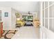 Bright and airy living room with tile flooring and sliding glass doors to a screened lanai at 6652 Brambleleaf Dr, Spring Hill, FL 34606