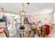 Open concept living area with tiled floors, modern lighting, and comfortable seating arrangement with an open view to the kitchen at 6652 Brambleleaf Dr, Spring Hill, FL 34606