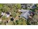 Aerial view of a quaint home surrounded by a canopy of lush, mature trees in a serene neighborhood at 7150 Park Dr, New Port Richey, FL 34652