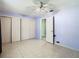 Bedroom boasting tile floors, ceiling fan, and ample closet space at 7150 Park Dr, New Port Richey, FL 34652