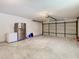 Garage with a stainless steel refrigerator, an upright freezer, and an automatic garage door at 7150 Park Dr, New Port Richey, FL 34652