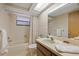 Cozy bathroom featuring a bathtub, shower, and a vanity with an oval sink, plus a window for natural light at 7426 Nova Scotia Dr, Port Richey, FL 34668