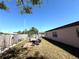 Spacious backyard features a cozy lounge set, a fence, and grass at 8053 Hixton Dr, Port Richey, FL 34668