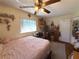 Bedroom with a ceiling fan, one window, and neutral decor at 8053 Hixton Dr, Port Richey, FL 34668