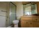 Bathroom featuring shower with glass door, toilet, and sink at 8121 Casuarina Dr, Port Richey, FL 34668