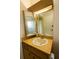 Bathroom vanity features a sink, mirror, and wood cabinets at 8121 Casuarina Dr, Port Richey, FL 34668