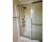 Bathroom features a glass enclosed shower with updated fixtures at 8121 Casuarina Dr, Port Richey, FL 34668