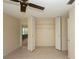 Bedroom with a spacious closet and neutral finishes at 8121 Casuarina Dr, Port Richey, FL 34668