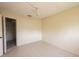 Bright bedroom with neutral tile flooring, ceiling fan and closet at 8121 Casuarina Dr, Port Richey, FL 34668
