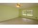 Bright bedroom featuring tile floors, and a large window, offering a serene space at 8121 Casuarina Dr, Port Richey, FL 34668