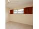Bright bedroom with neutral tile flooring, ceiling fan and ample natural light at 8121 Casuarina Dr, Port Richey, FL 34668