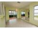 Bright dining room with neutral tile flooring, sliding glass doors and accent mirrored wall at 8121 Casuarina Dr, Port Richey, FL 34668