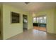 Bright dining room features neutral tile flooring, sliding glass doors and convenient pass-through to kitchen at 8121 Casuarina Dr, Port Richey, FL 34668