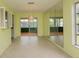Bright dining room with neutral tile flooring, sliding glass doors and accent mirrored wall at 8121 Casuarina Dr, Port Richey, FL 34668