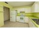 Functional kitchen boasts white appliances, tiled floors, and ample cabinet and counter space at 8121 Casuarina Dr, Port Richey, FL 34668