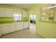 Well-lit kitchen featuring white cabinetry and a practical layout perfect for cooking at 8121 Casuarina Dr, Port Richey, FL 34668