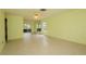 Spacious living room with tile flooring, ample lighting, and a seamless open layout at 8121 Casuarina Dr, Port Richey, FL 34668