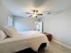 Well-lit bedroom with a ceiling fan, carpeted floor and neutral tones at 8132 Capstone Ranch Dr, New Port Richey, FL 34655