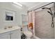 Modern bathroom with stylish marble tile and a shower head with handheld attachment at 8626 White Springs Dr, New Port Richey, FL 34655