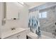 This bathroom features marble-style tiling, modern fixtures, and a tub with a shower at 8626 White Springs Dr, New Port Richey, FL 34655