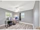 A bedroom with wood look floors, a ceiling fan, and two workstations at 8626 White Springs Dr, New Port Richey, FL 34655