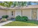 The front entrance of the home has lush landscaping and a beige exterior with rock accents at 8626 White Springs Dr, New Port Richey, FL 34655
