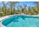 Sparkling community pool surrounded by a secure fence and lounge chairs at 8626 White Springs Dr, New Port Richey, FL 34655