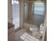 Tiled bathroom with shower/tub, toilet, and vanity at 8630 Ne Coral Creek Loop, Hudson, FL 34667