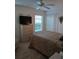 Comfortable bedroom offering a ceiling fan, natural light, and closet at 8630 Ne Coral Creek Loop, Hudson, FL 34667