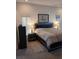 Well-lit bedroom featuring a ceiling fan, soft carpet, and neutral walls at 8630 Ne Coral Creek Loop, Hudson, FL 34667