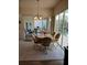 Charming dining area with tile floors, decorative chandelier and sliding doors to the pool area at 8630 Ne Coral Creek Loop, Hudson, FL 34667