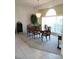 Elegant dining room with a chandelier and lots of natural light from large windows at 8630 Ne Coral Creek Loop, Hudson, FL 34667