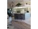 Bright and airy kitchen with an island, pendant lighting, and views into the living area at 8630 Ne Coral Creek Loop, Hudson, FL 34667